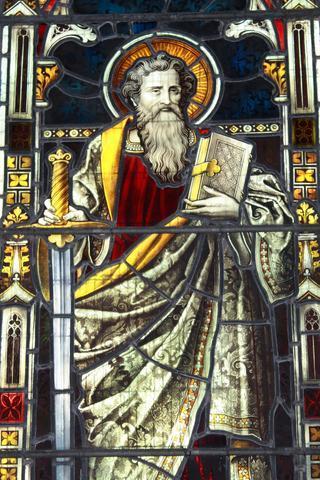 The apostle Paul Stained glass of the the apostle Paul, with a book and a sword. Primary colours are red, brown and yellow.