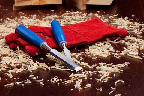 Chisels, red carpenters gauntlets, and wood chips