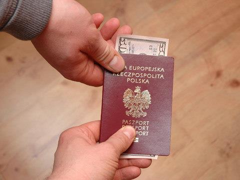 Polish passport containing a 50 dollar bribe changes hands